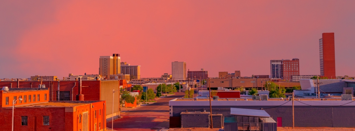 Looking Down At The Downtown District, With A Brilliant Sunset