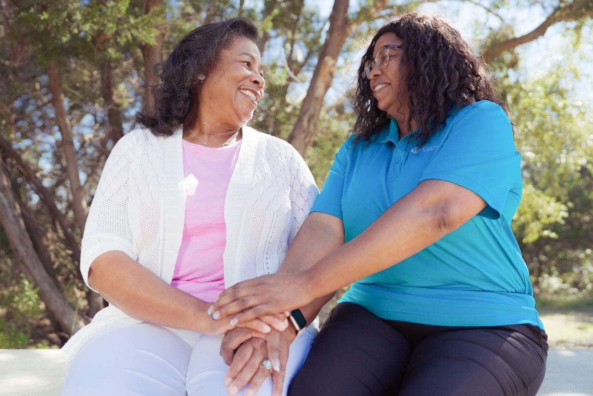 Caregiver and veteran holding hands