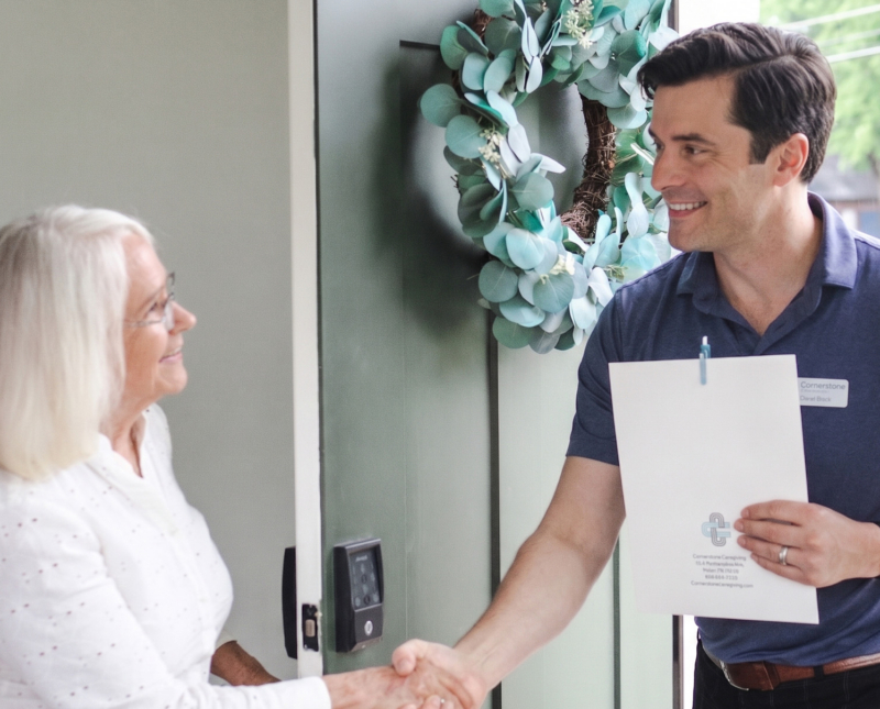 Operating Director introducing himself to senior at their home