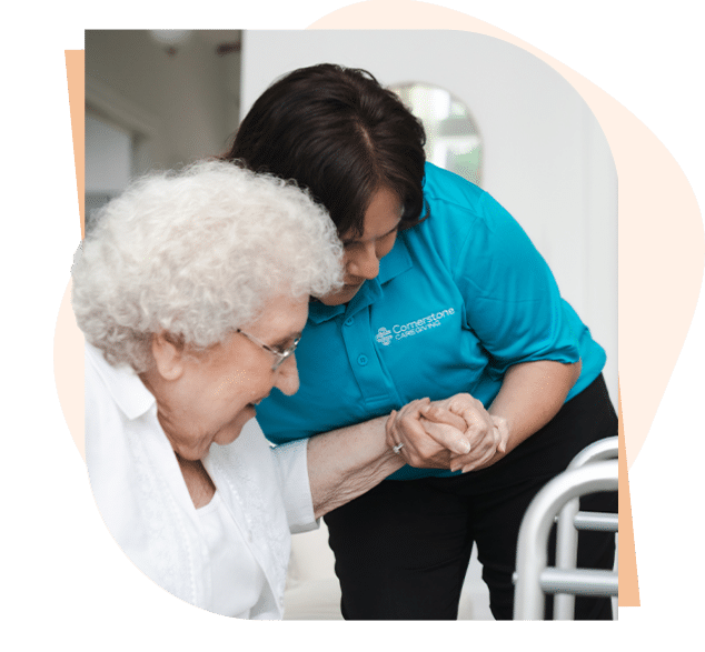 Caregiver assisting senior client stand up