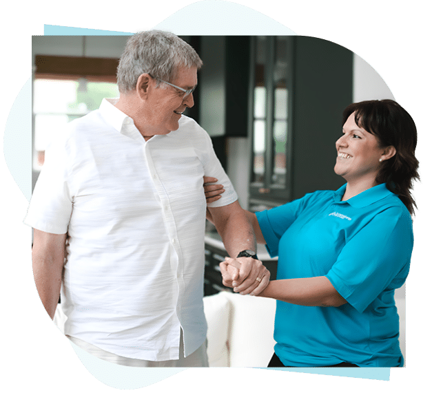 Caregiver helping senior standing up