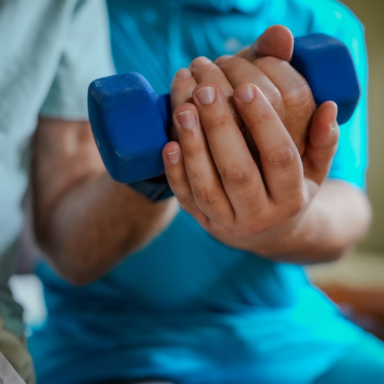 Caregiver helping senior lift weight