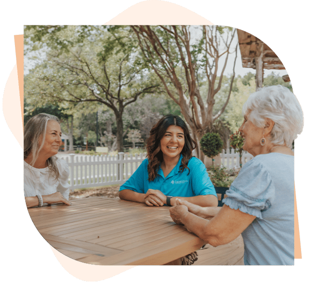 Caregiver meeting with senior client and her daughter